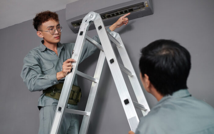 Workers Installing Air Conditioner